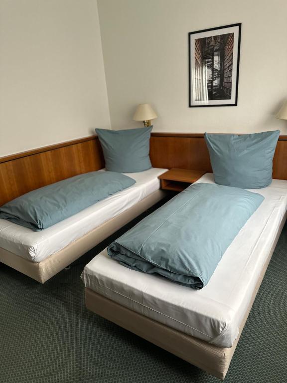 Postel nebo postele na pokoji v ubytování Hotel Graßer