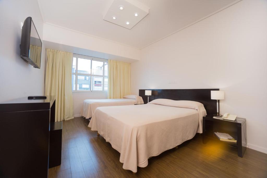 Ένα ή περισσότερα κρεβάτια σε δωμάτιο στο Hotel Versailles