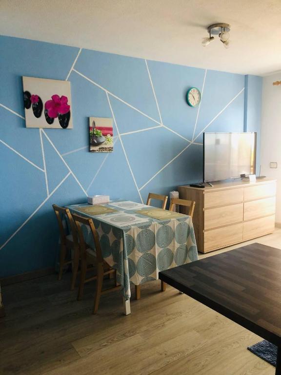 A television and/or entertainment centre at First Line Beach Apartment with Ocean View La Arena