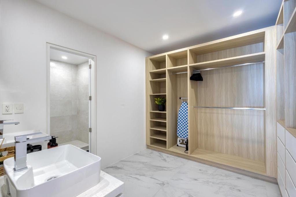 a bathroom with a white sink and a shower at Lumina at Marea Cabo San Lucas in Cabo San Lucas
