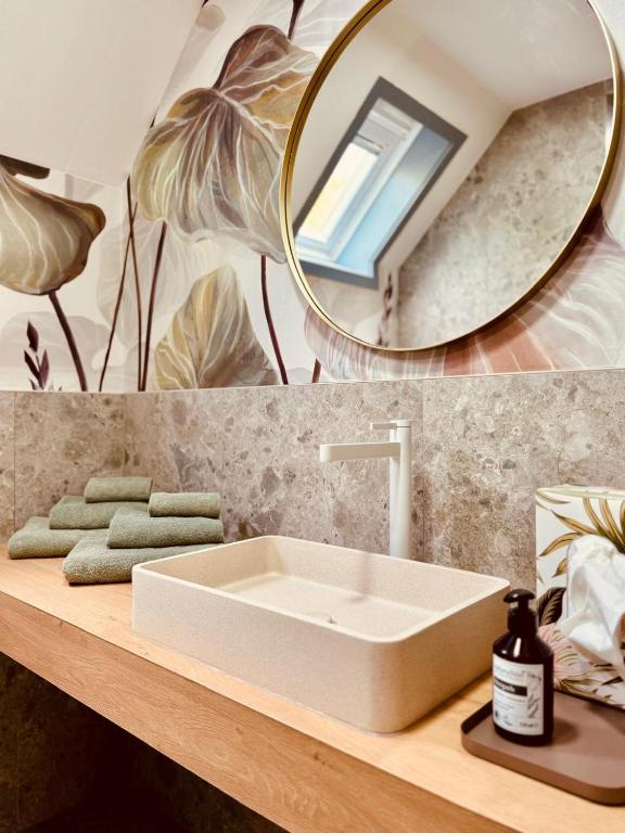a bathroom with a white sink and a mirror at leaf in Kirchheim