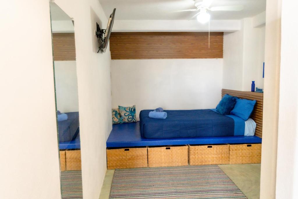 a bedroom with a blue bed in a room at Casa Arrecife Tortuga, Fast Internet, private Cozy room in La Ventana