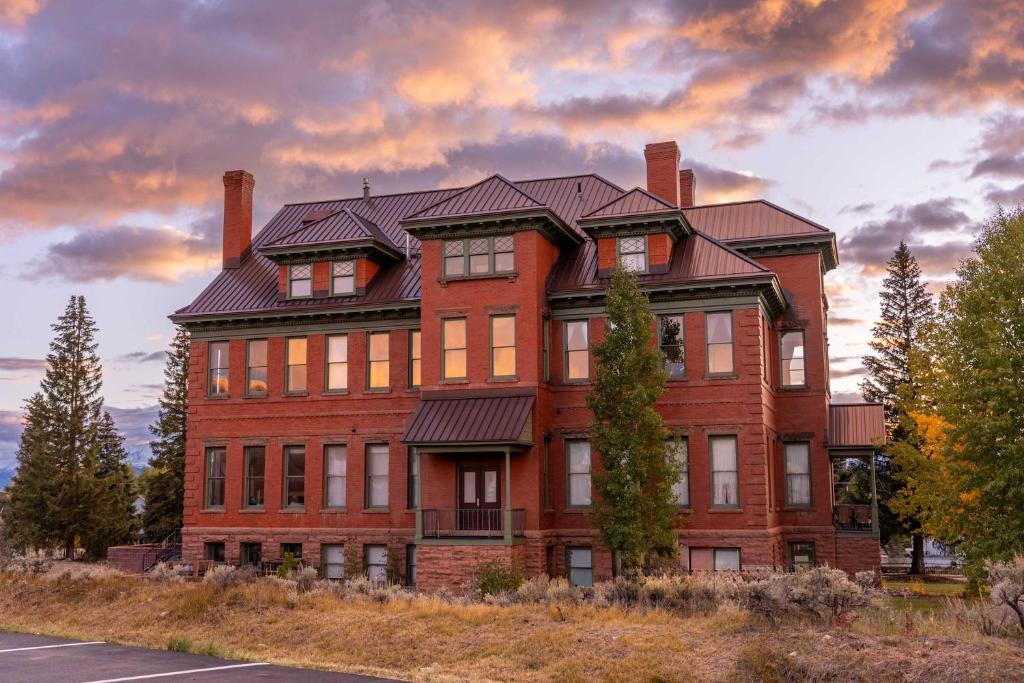 a large red brick building on the side of a street at Papa's Place - blocks from downtown in Leadville