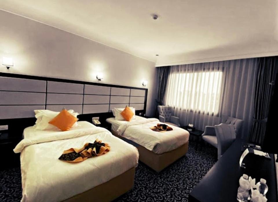 Ένα ή περισσότερα κρεβάτια σε δωμάτιο στο Jakarta hotel