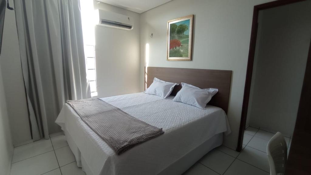 En eller flere senge i et værelse på Pousada Sousa&Araújo