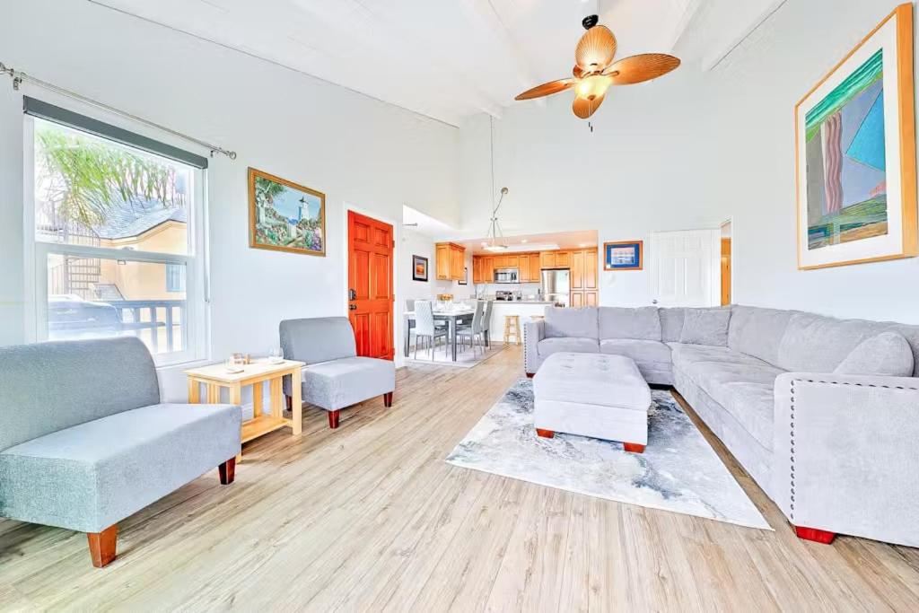 a living room with a couch and a table at Oceanfront Condo in Newport Beach with Private Balcony and Perfect Location by the Pier in Newport Beach