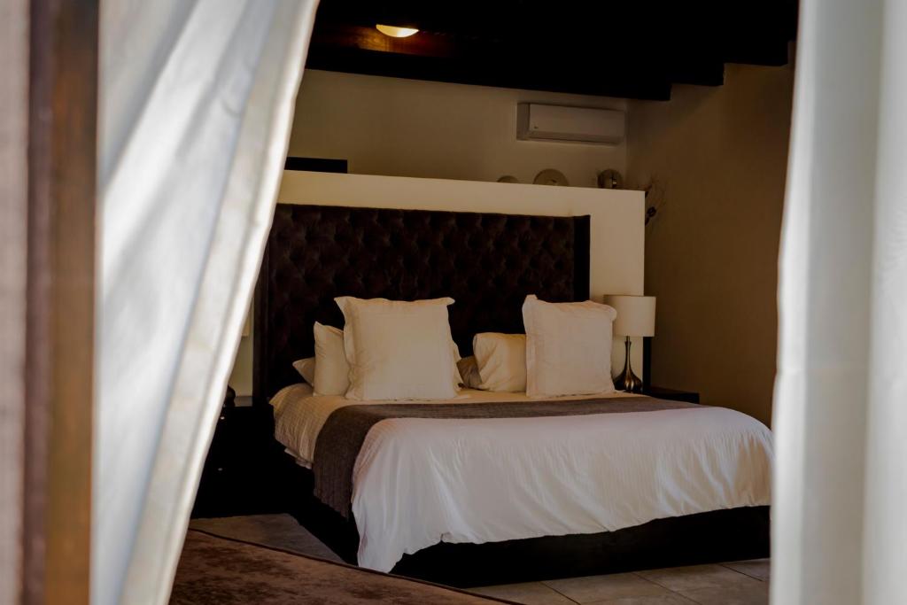 Postel nebo postele na pokoji v ubytování Hotel Boutique Hacienda Guadalupe
