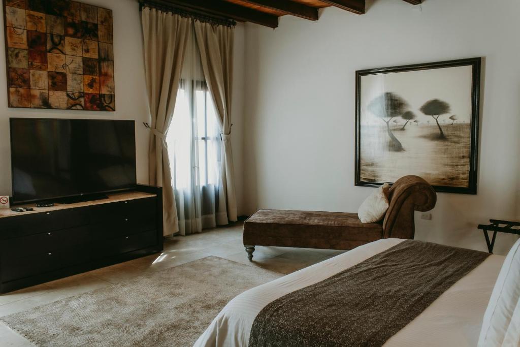 Postel nebo postele na pokoji v ubytování Hotel Boutique Hacienda Guadalupe