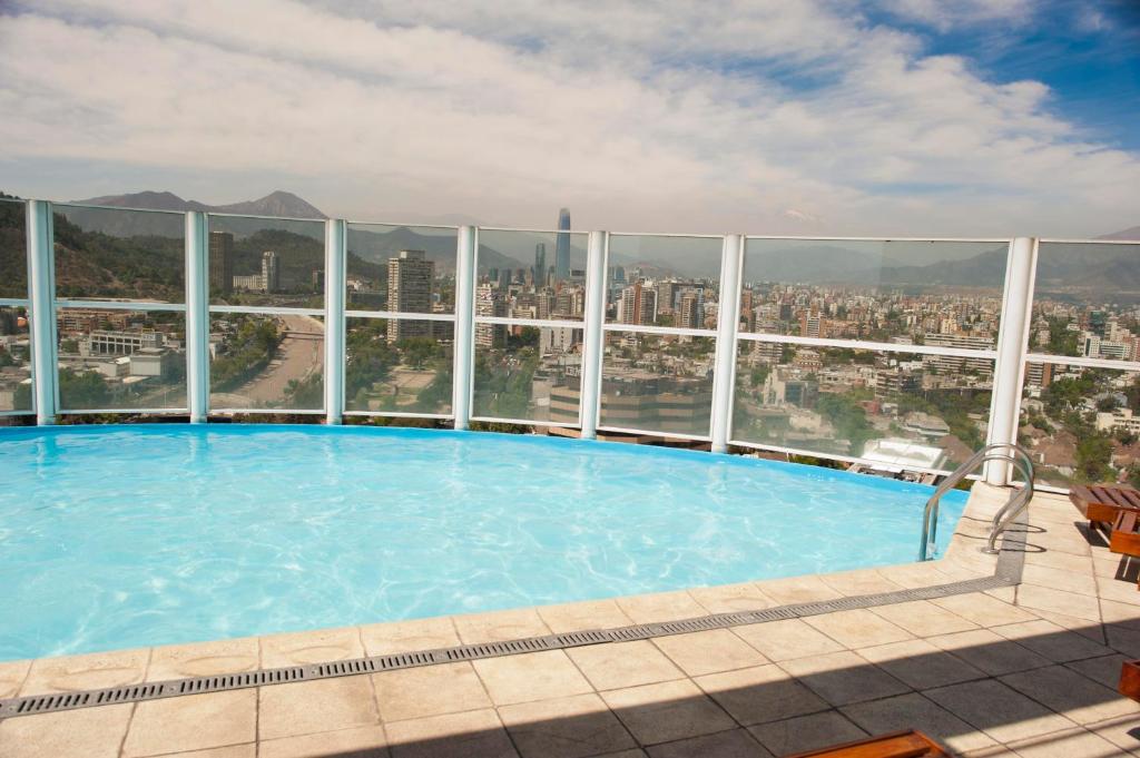 a large swimming pool on the top of a building at Chilean Suites Providencia II in Santiago