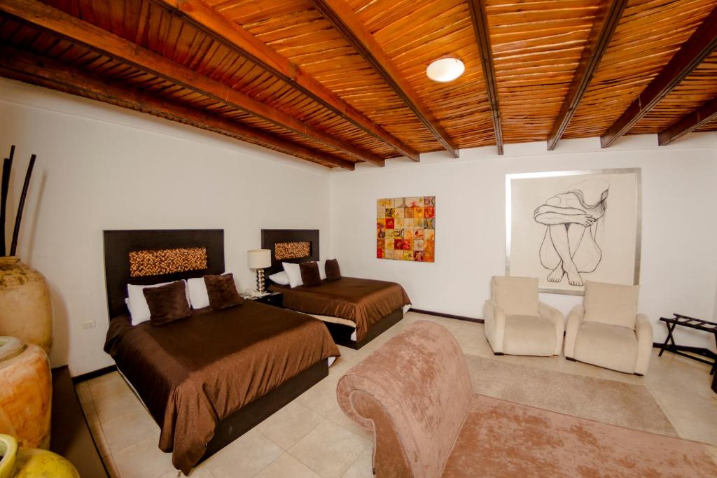 Postel nebo postele na pokoji v ubytování Hotel Boutique Hacienda Guadalupe