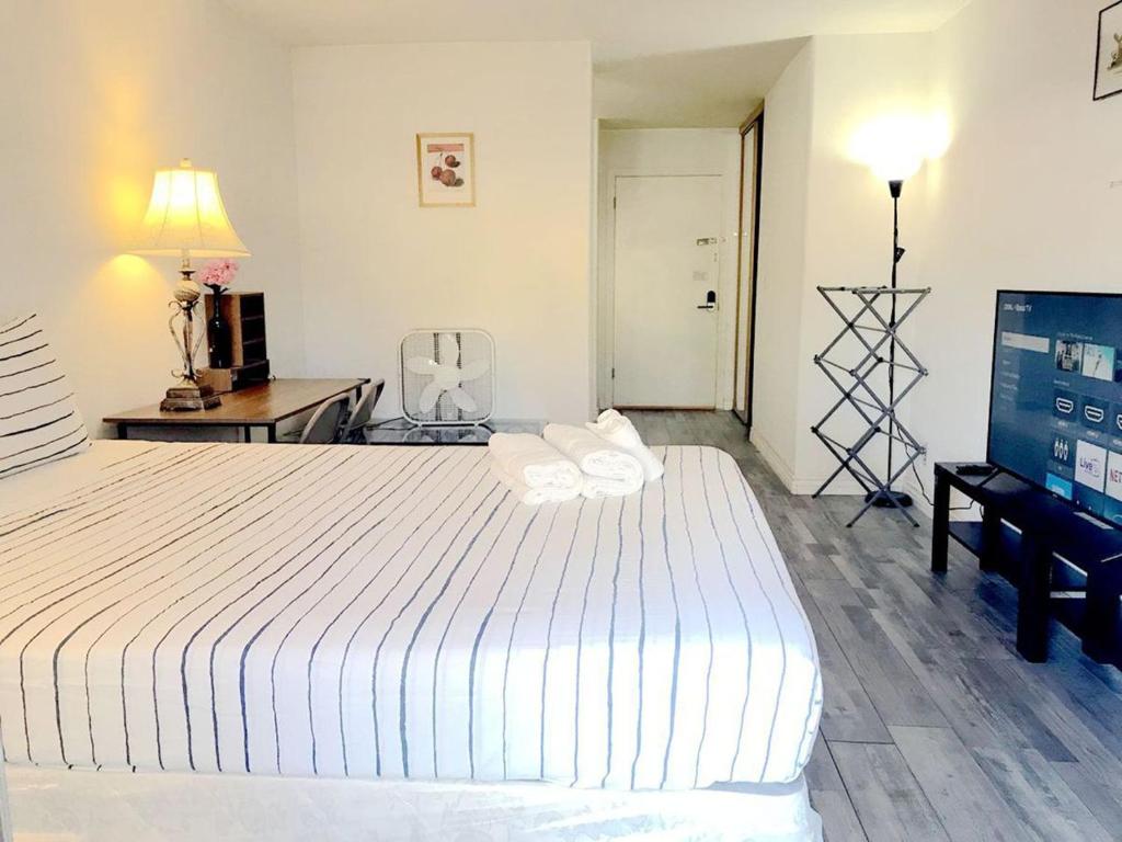 a bedroom with a large white bed and a desk at Super bedroom with private bathroom 5 in Las Vegas