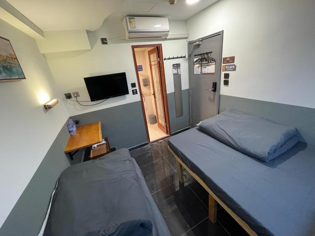 Letto o letti in una camera di 香港榆臨賓館 Yulam Guesthouse