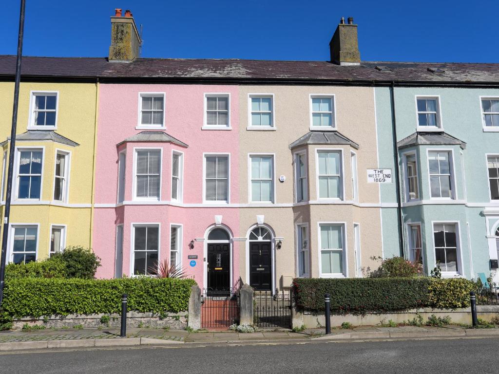a row of brightly colored houses on a street at Lluest in Beaumaris