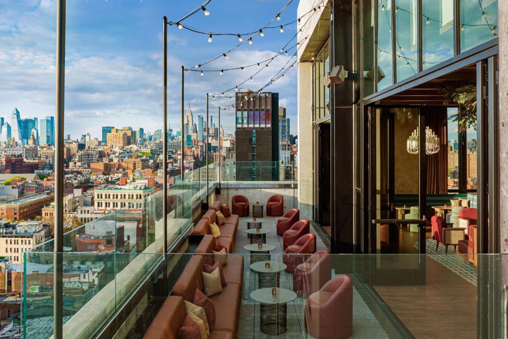 a restaurant with a view of a city at Moxy NYC Lower East Side in New York
