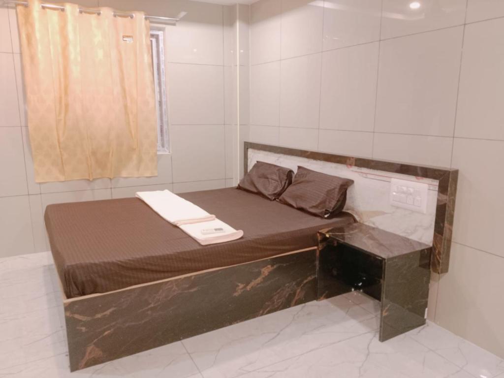 Postel nebo postele na pokoji v ubytování GM Residency