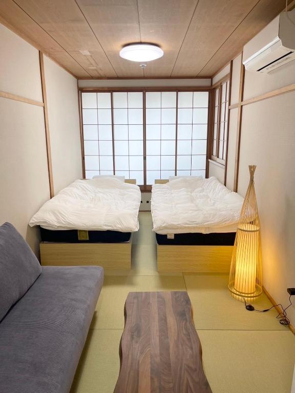 Postel nebo postele na pokoji v ubytování Sakura Hotel Hatagaya