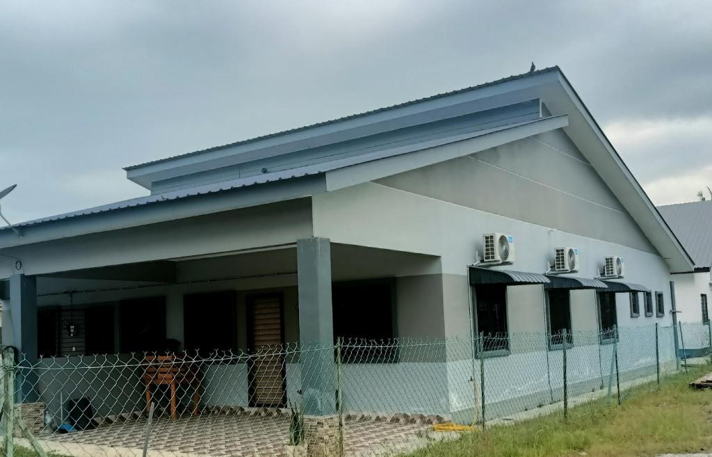 a white building with a fence in front of it at SaFa HOMESTAY PULAU INDAH in Pulau Indah