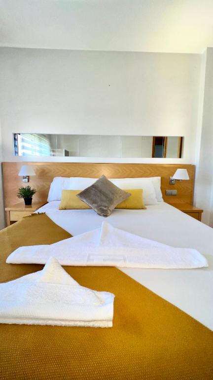 two beds in a room with towels on them at House Samaniego 12 in Madrid