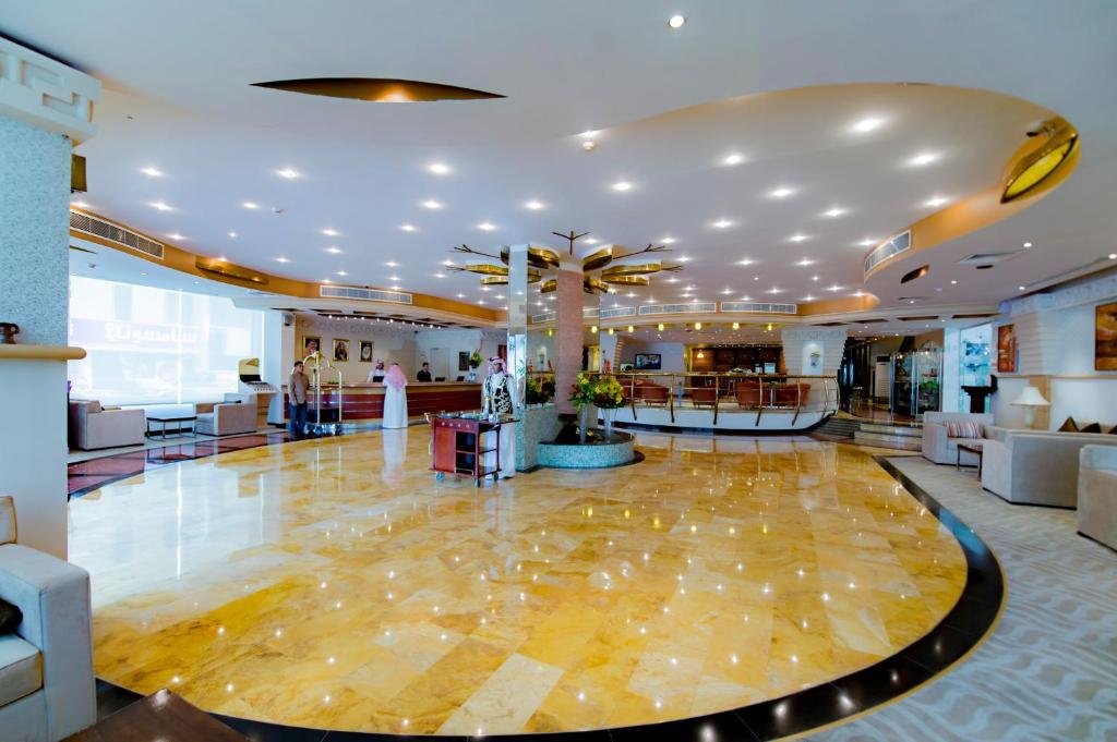 a lobby of a hotel with a palm tree at Boudl Khurais in Riyadh