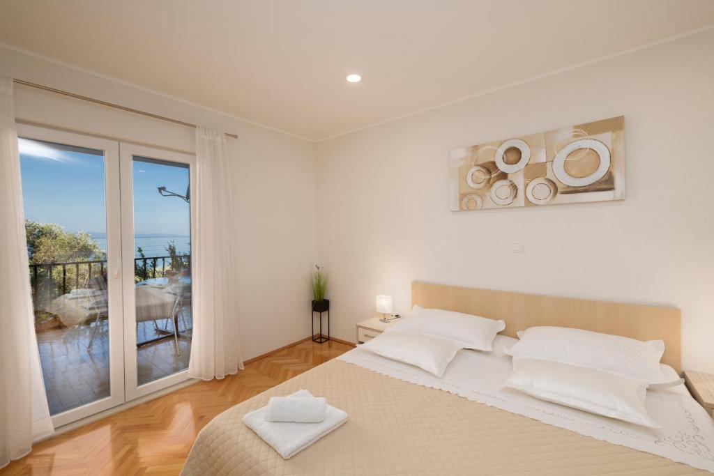 Postel nebo postele na pokoji v ubytování Apartmani Marta
