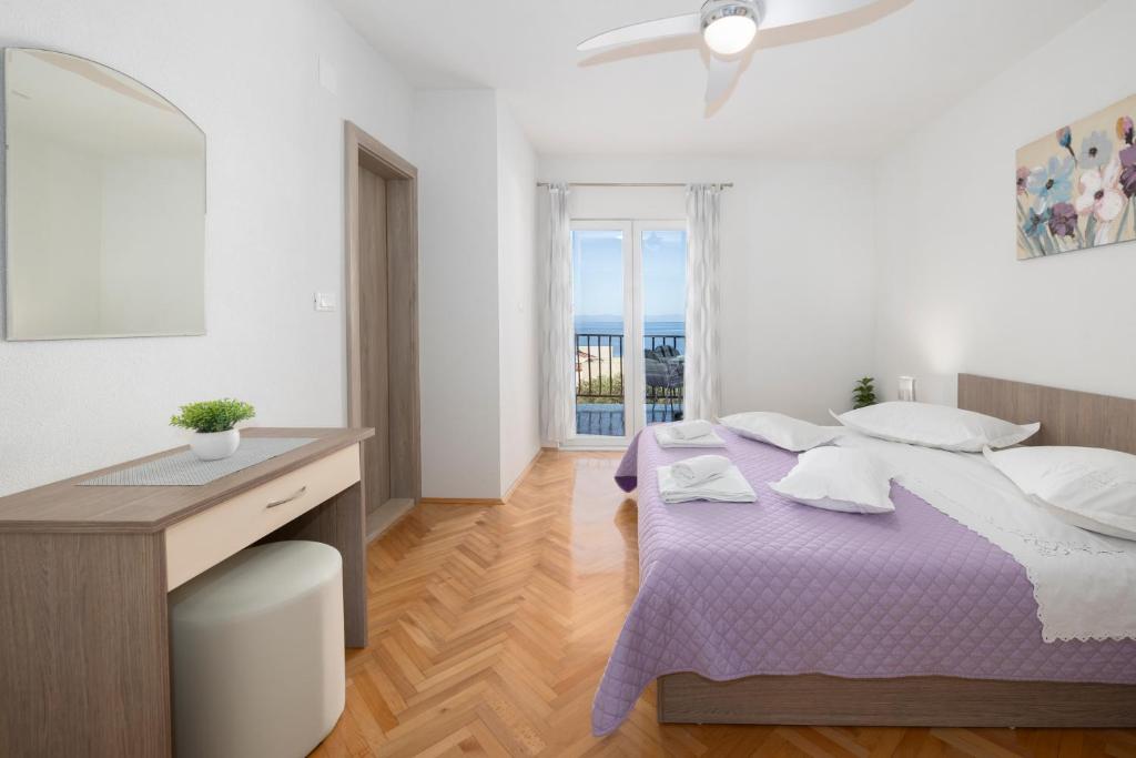 Postel nebo postele na pokoji v ubytování Apartmani Marta