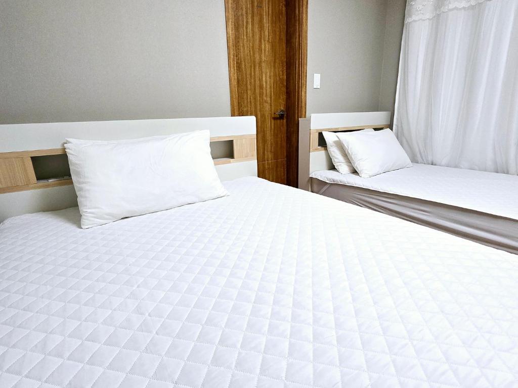 Postel nebo postele na pokoji v ubytování Incheon airport Guesthouse L