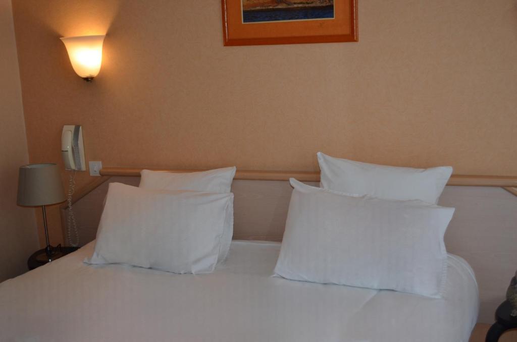 Postel nebo postele na pokoji v ubytování Hôtel du Parc