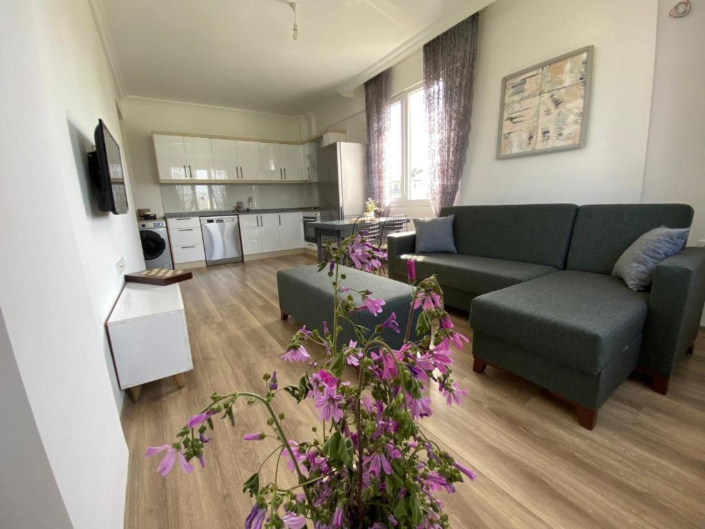a living room with a couch and a kitchen at Dalaman Çınar Apart in Dalaman
