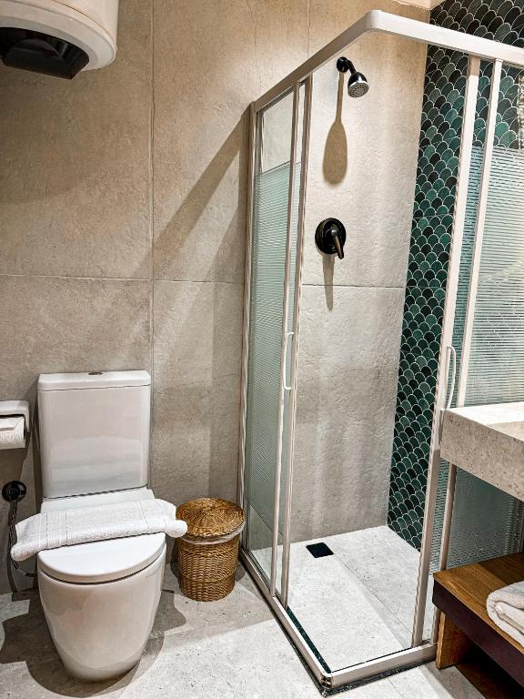 a bathroom with a shower with a toilet and a sink at Jimmy Pyramids Hotel in Cairo