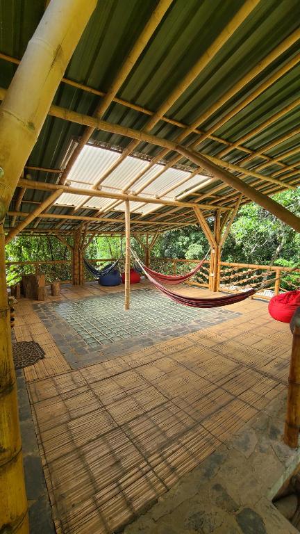 a room with a hammock in a building at Colibamboo Ecolodge Biocasa artesanal rodeada de naturaleza con jaccuzi y mucho más in Pacho