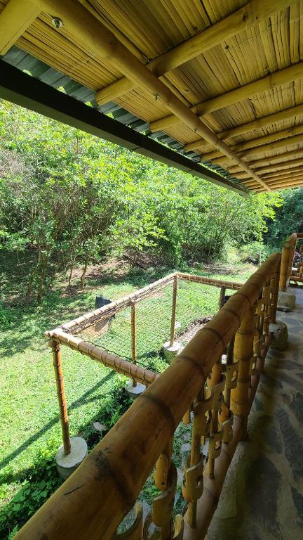 a group of wooden logs sitting under a roof at Colibamboo Ecolodge Biocasa artesanal rodeada de naturaleza con jaccuzi y mucho más in Pacho