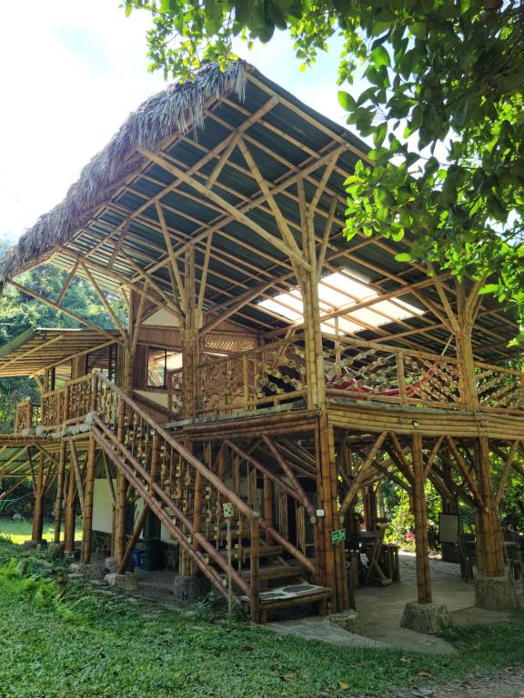 a large bamboo house with a thatched roof at Colibamboo Ecolodge Biocasa artesanal rodeada de naturaleza con jaccuzi y mucho más in Pacho