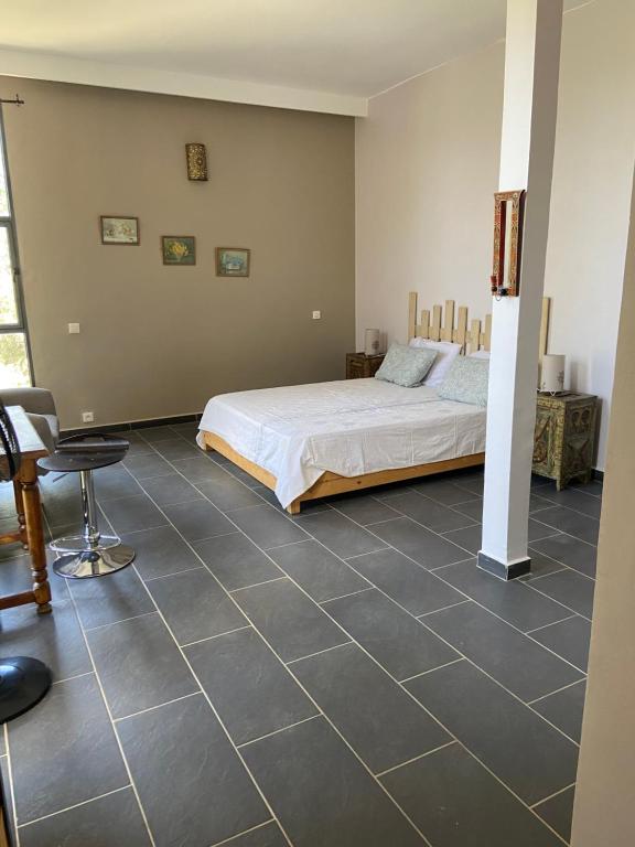 Postel nebo postele na pokoji v ubytování Dar Harmattan