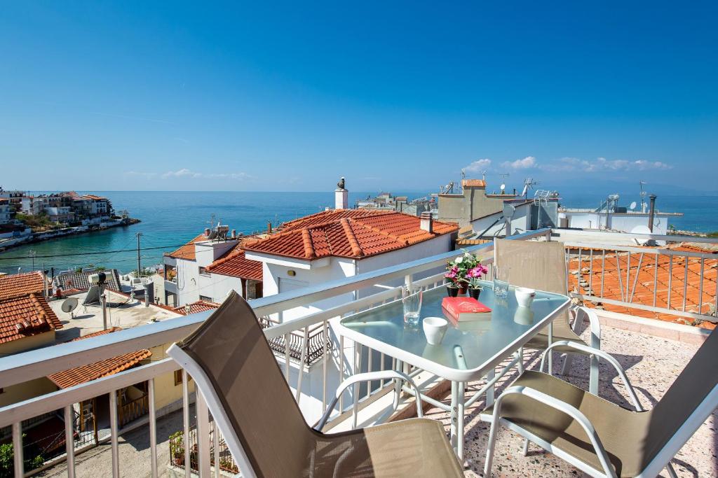 balkon ze stołem i krzesłami oraz oceanem w obiekcie "Thea" Apartment 1 w mieście Skala Marion