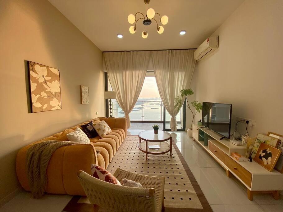 a living room with a couch and a tv at Country Garden Danga Bay,Full Seaview, 6-8pax, Netflix in Johor Bahru