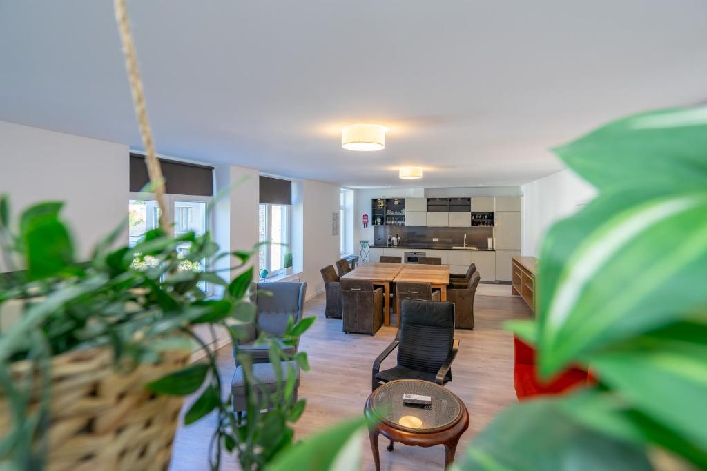 a living room with a table and chairs and a kitchen at Les Variétés in La-Roche-en-Ardenne