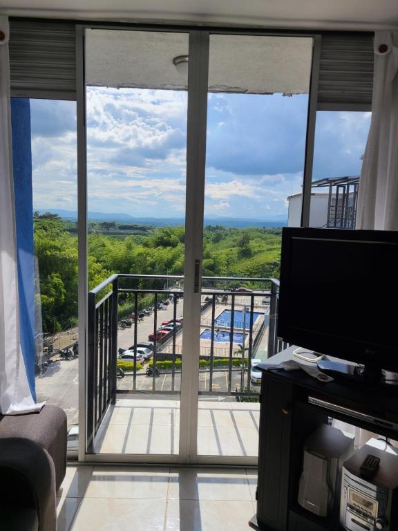 a living room with a view of a balcony at Apartamento Armenia, como en casa! in Armenia