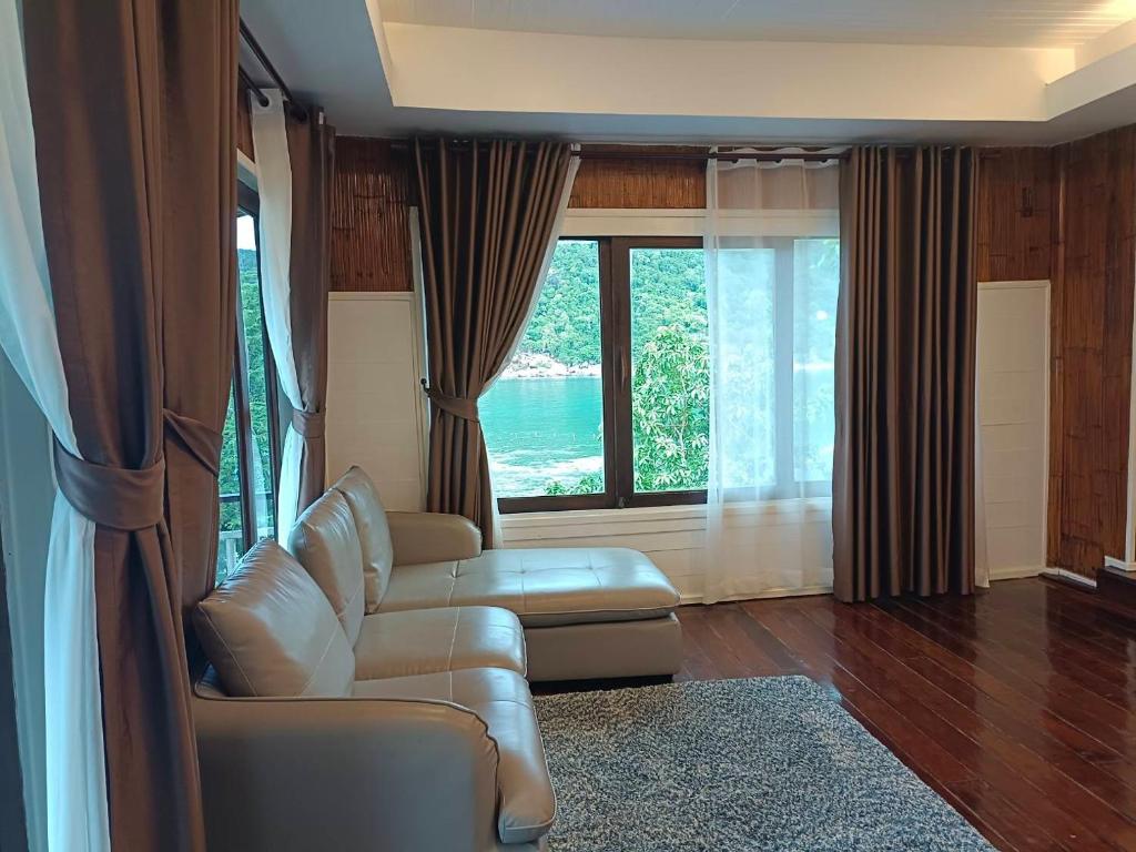 a living room with a couch and a window at Nangyuan Island Dive Resort in Ko Tao
