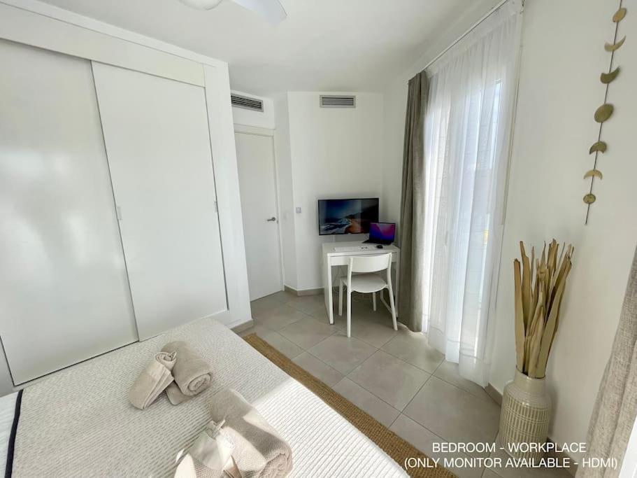A television and/or entertainment centre at La Cabanana - Apartment w pool and high-speed WiFi