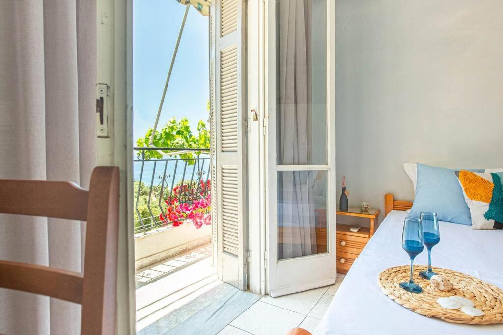 a bedroom with a bed with a view of a balcony at Blue Maraçi 1 Beach Access nd Parking in Himare