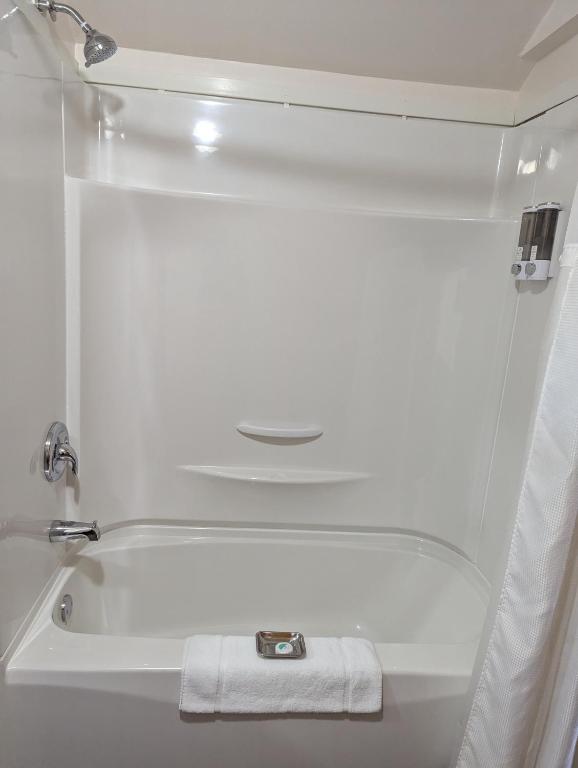 a white bath tub with a white towel in a bathroom at The Parrsboro Mansion Inn in Parrsboro