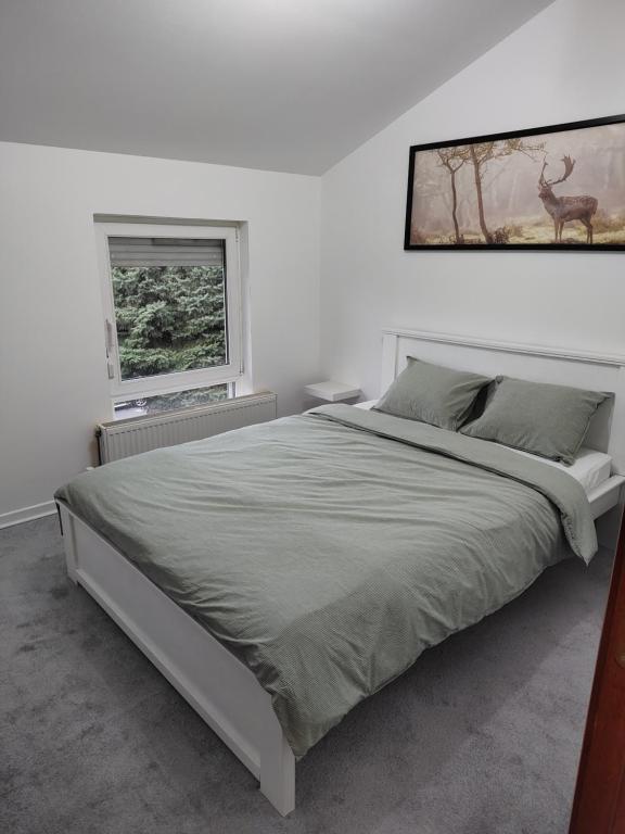 Ένα ή περισσότερα κρεβάτια σε δωμάτιο στο Apartman Ingrid