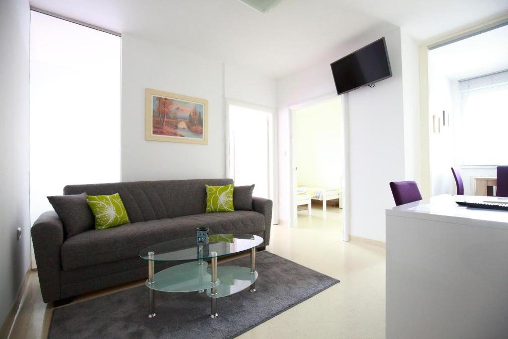a living room with a couch and a table at Apartment Hurcak in Zagreb