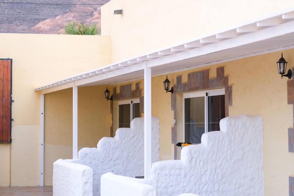 a white house with white stairs in front of it at Club JM Lanzarote in Tabayesco