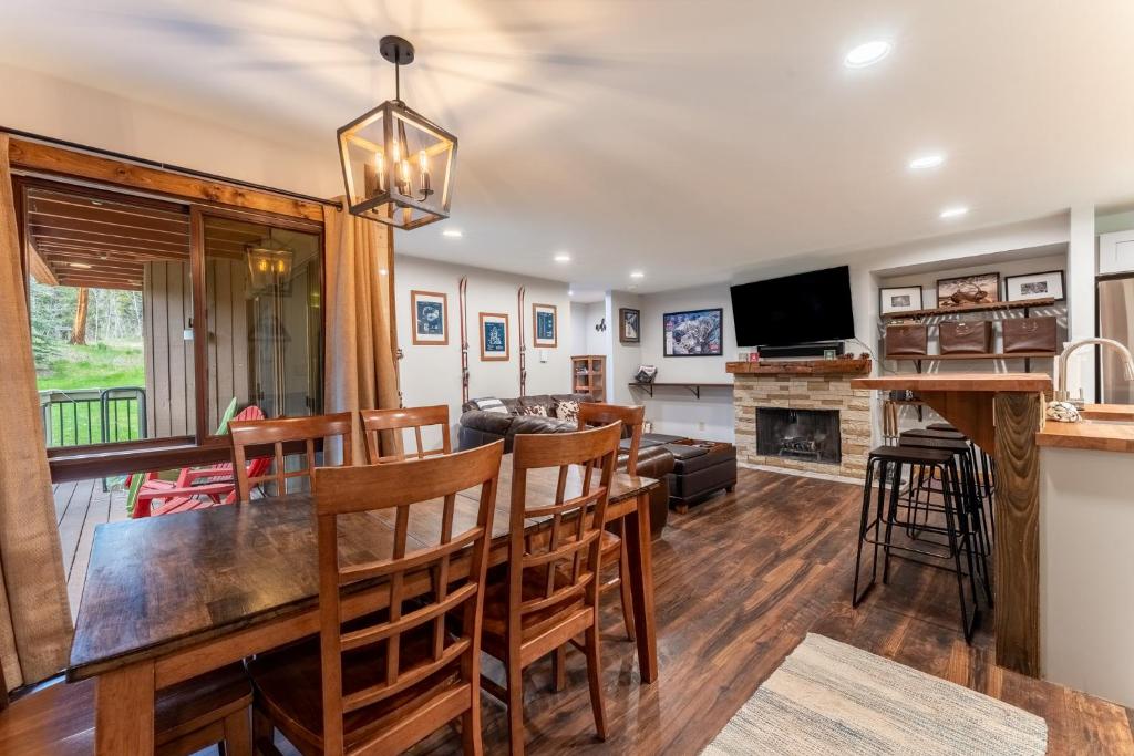 a dining room and living room with a table and chairs at Wild Irishman #1030 by Summit County Mountain Retreats in Keystone
