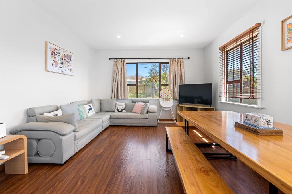 a living room with a couch and a table at Lakeview Oasis in Rotorua