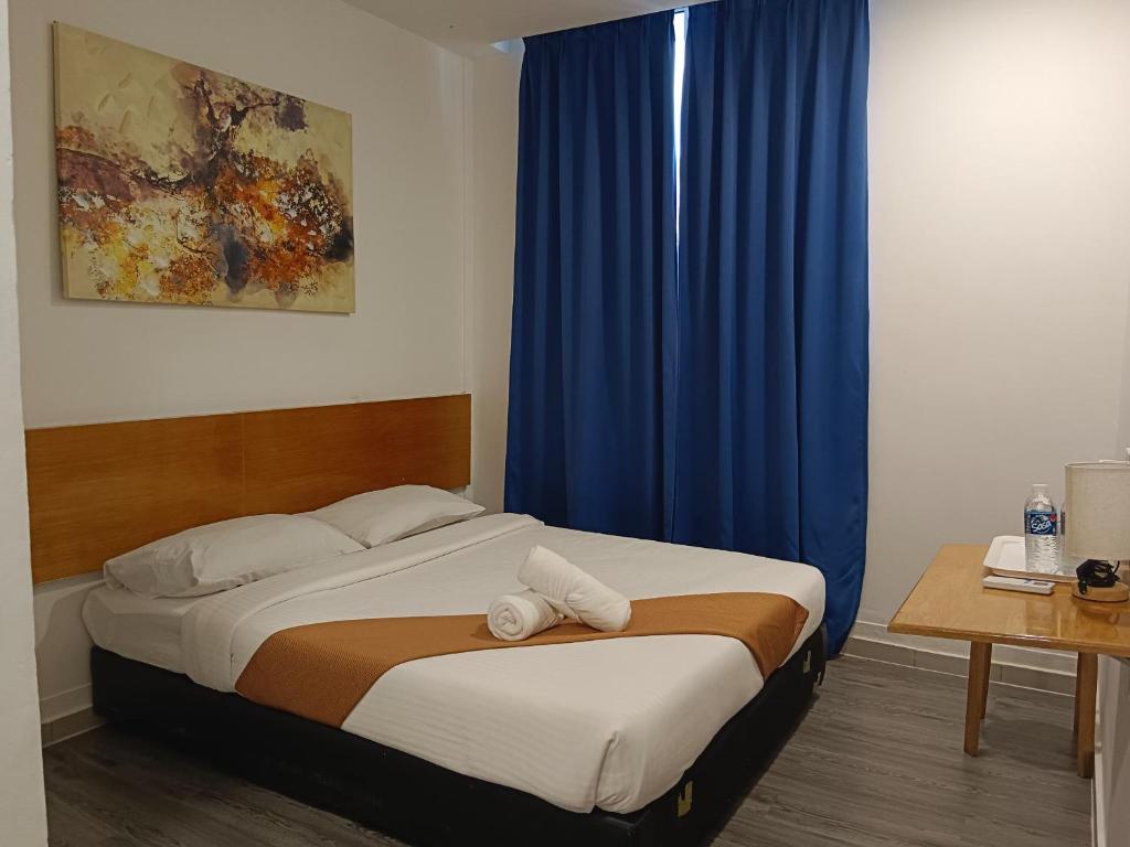 Postel nebo postele na pokoji v ubytování Nunuk Ragang Hotel