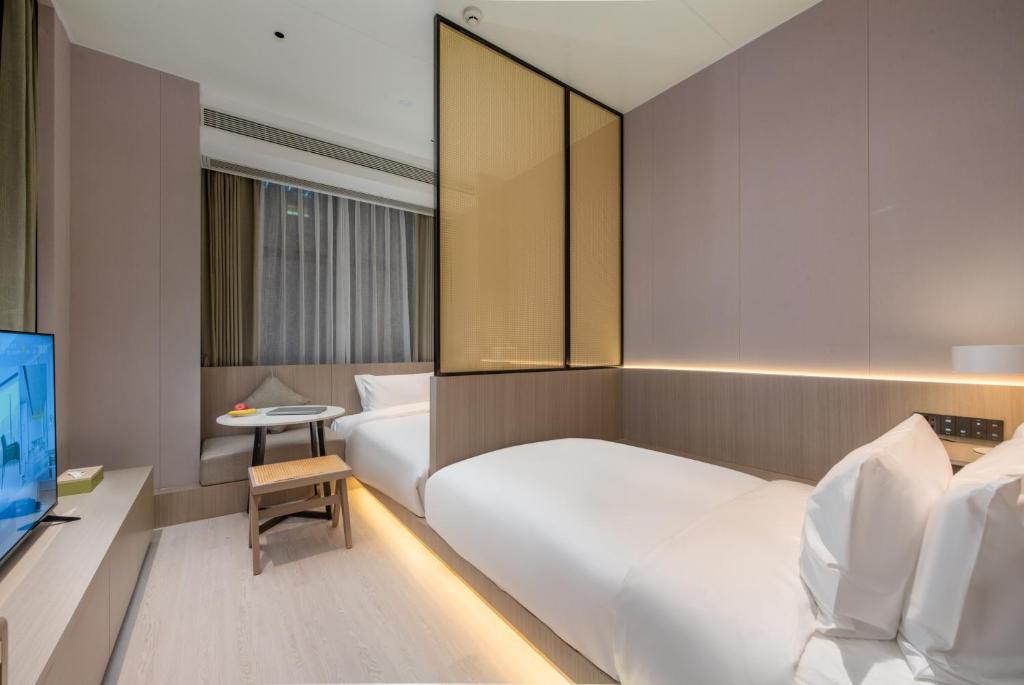 TV a/nebo společenská místnost v ubytování ONESS Executive Hotel Guangzhou Huangpu Luogang
