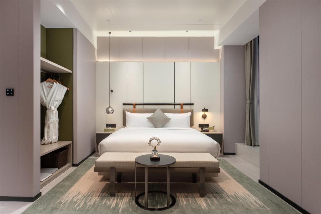 Postel nebo postele na pokoji v ubytování ONESS Executive Hotel Guangzhou Huangpu Luogang