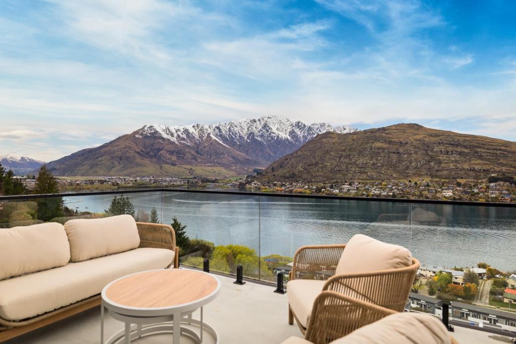 a balcony with a view of the water and mountains at WARNING Extreme views 4 bed 3 bath luxury in Queenstown